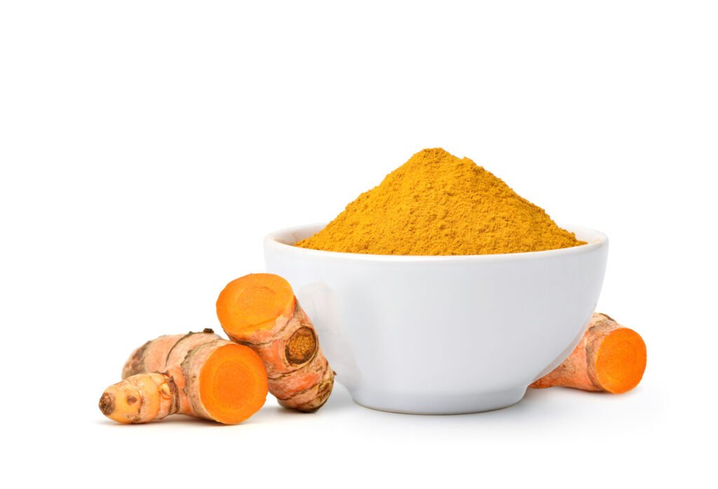 turmeric powder white bowl with rhizome slices isolated white